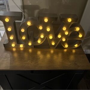 Silver Love Sign with Warm Yellow Lights